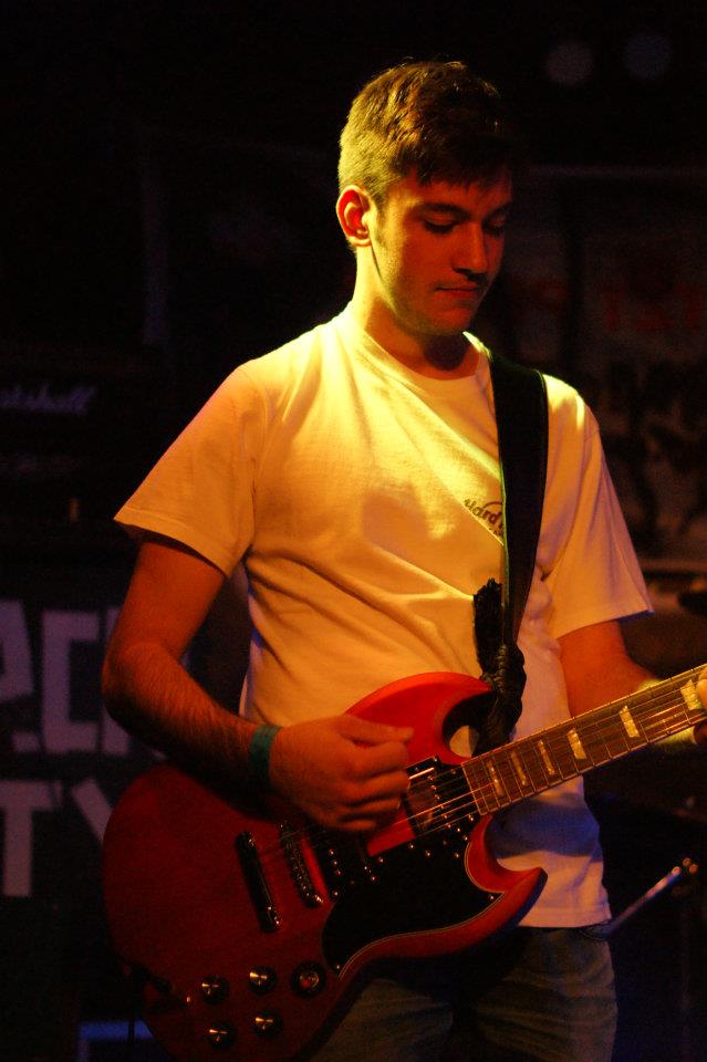 me, on stage, playing an electrical guitar